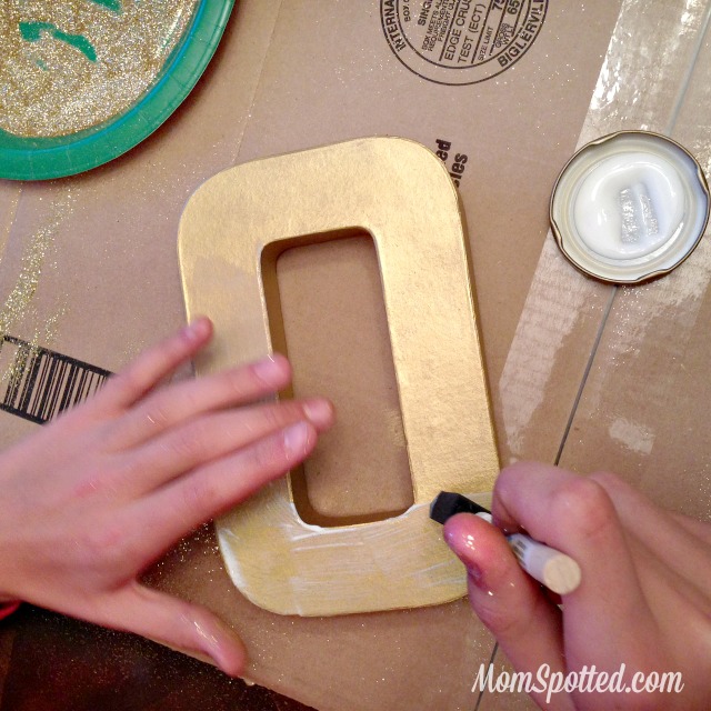 Make Your Own Gold Glittery Christmas Letter Decoration tutorial found on momspotted.com glitter, modge podge, christmas decor