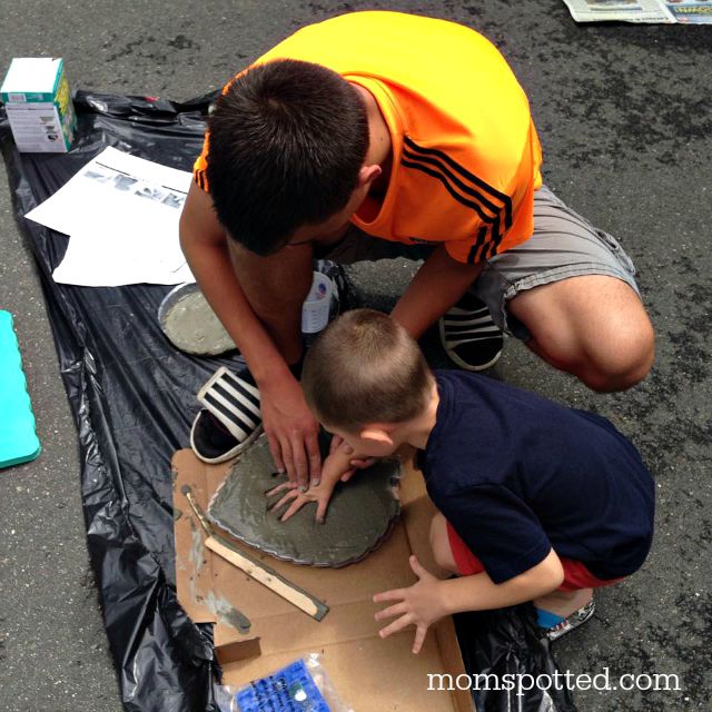 Brothers making handprints in stepping stones for our garden